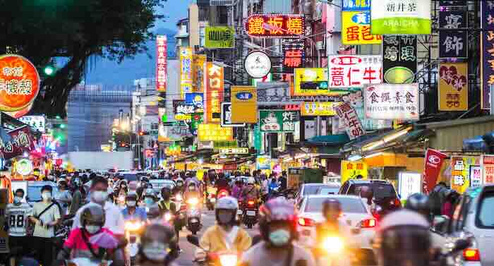 Busy street filled with colorful signs.