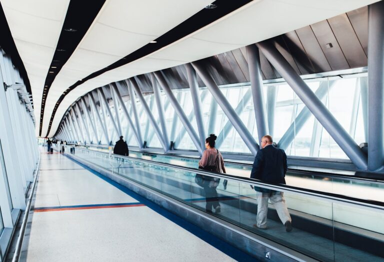 Modern airport terminal corridor with travelers - airport English vocabulary 機場英文