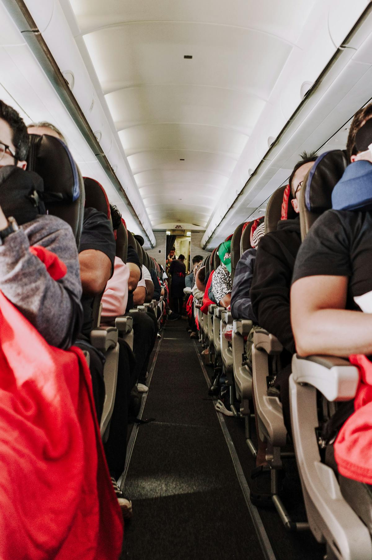 Passengers seated inside airplane cabin - airplane English phrases 飛機上英文對話