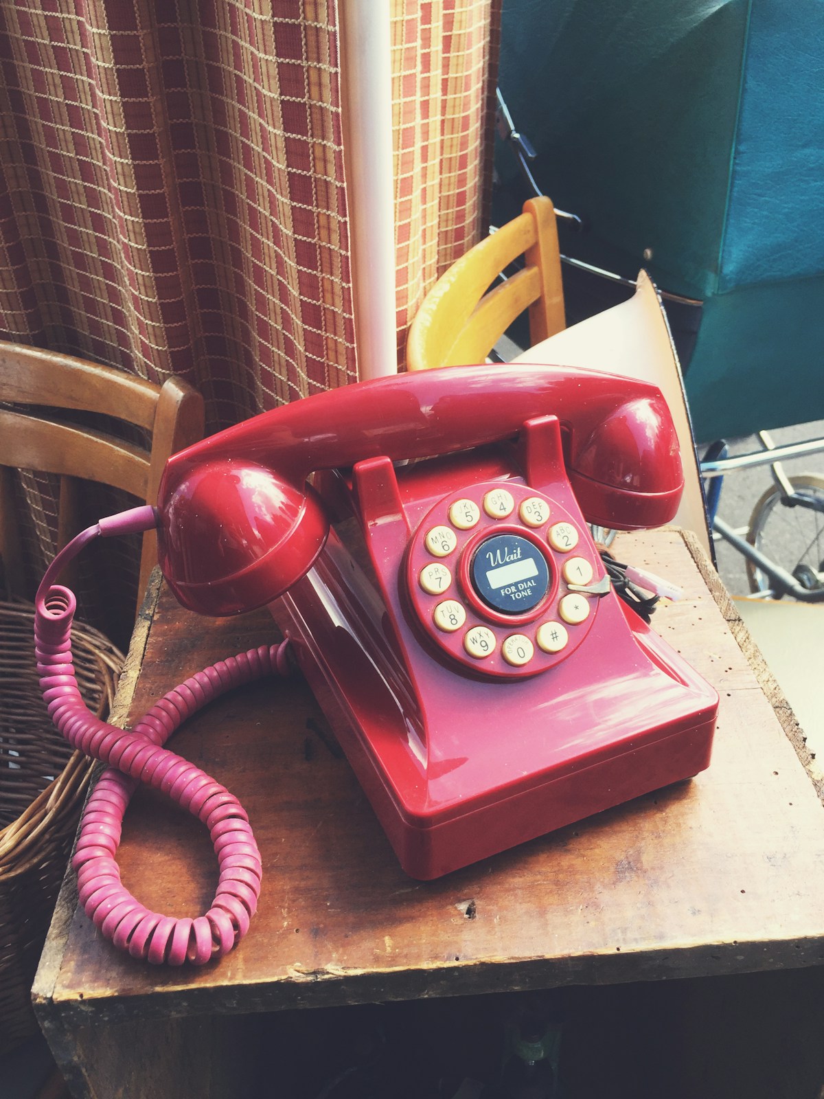 Classic red telephone on a wooden table