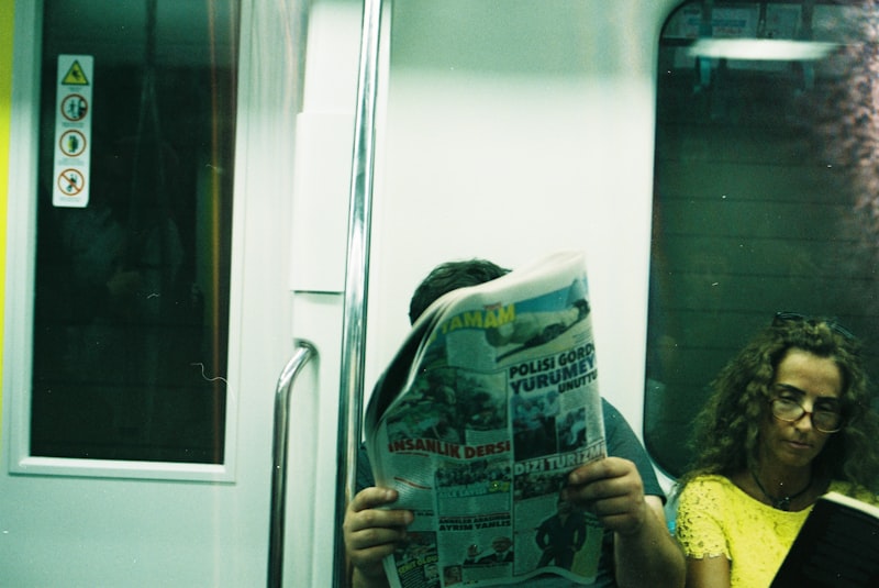 Person reading English newspaper with coffee in morning sunlight