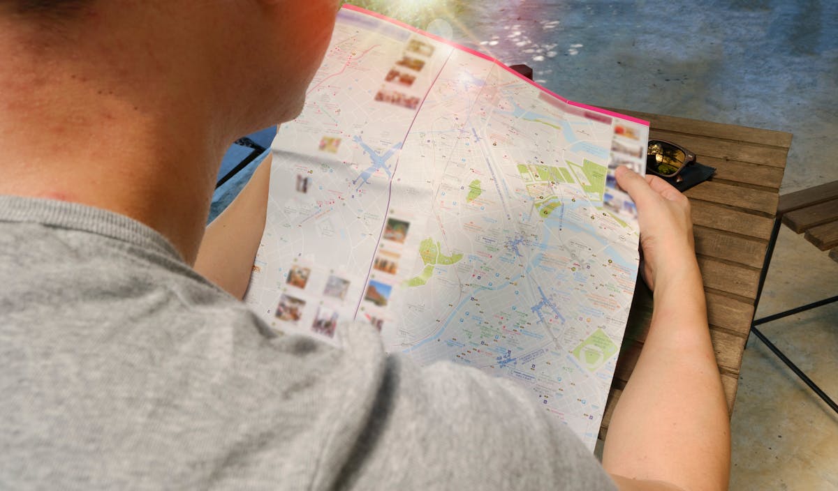 Traveler reading a map planning their route using travel English skills