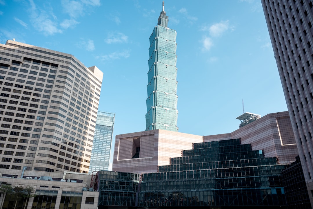 Modern skyscrapers under a clear blue sky.
