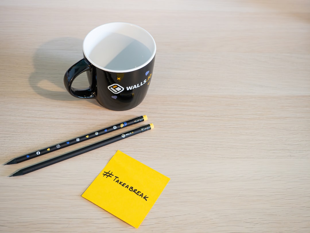 Desk with a mug, stationary and a sticky note with the hashtag #takeabreak