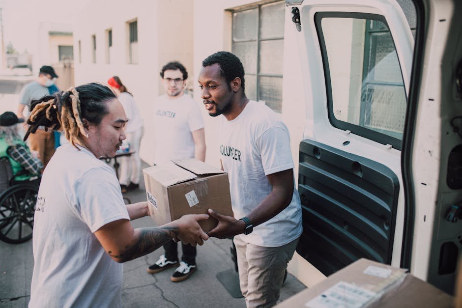 Volunteers working together to distribute donated supplies from a van. — body parts English idiom