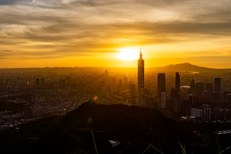 Golden hour view of Taipei skyline with Taipei 101 at sunrise, showcasing urban beauty.