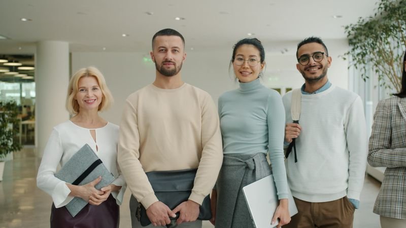 International team standing together — English self-introduction in workplace
