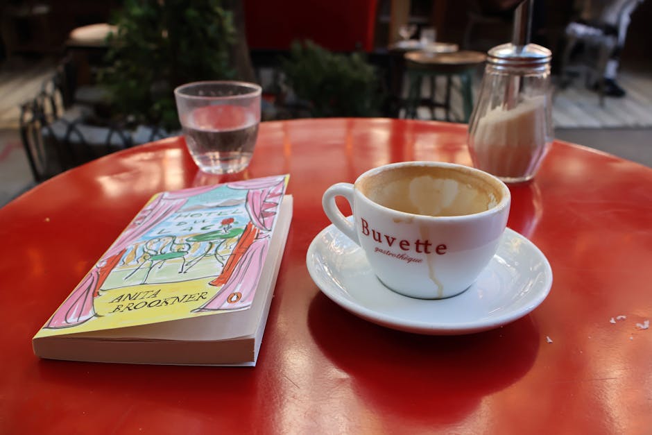 A coffee cup and book on a table in a New York outdoor cafe.
