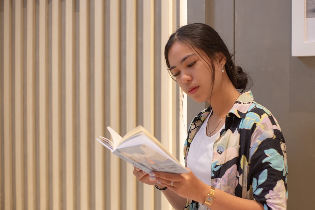 A woman is reading a book.