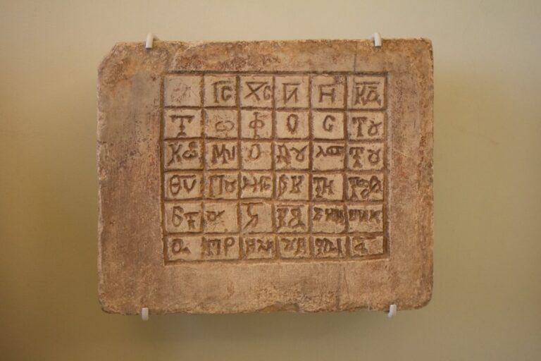 An ancient greek tombstone on display in a museum.