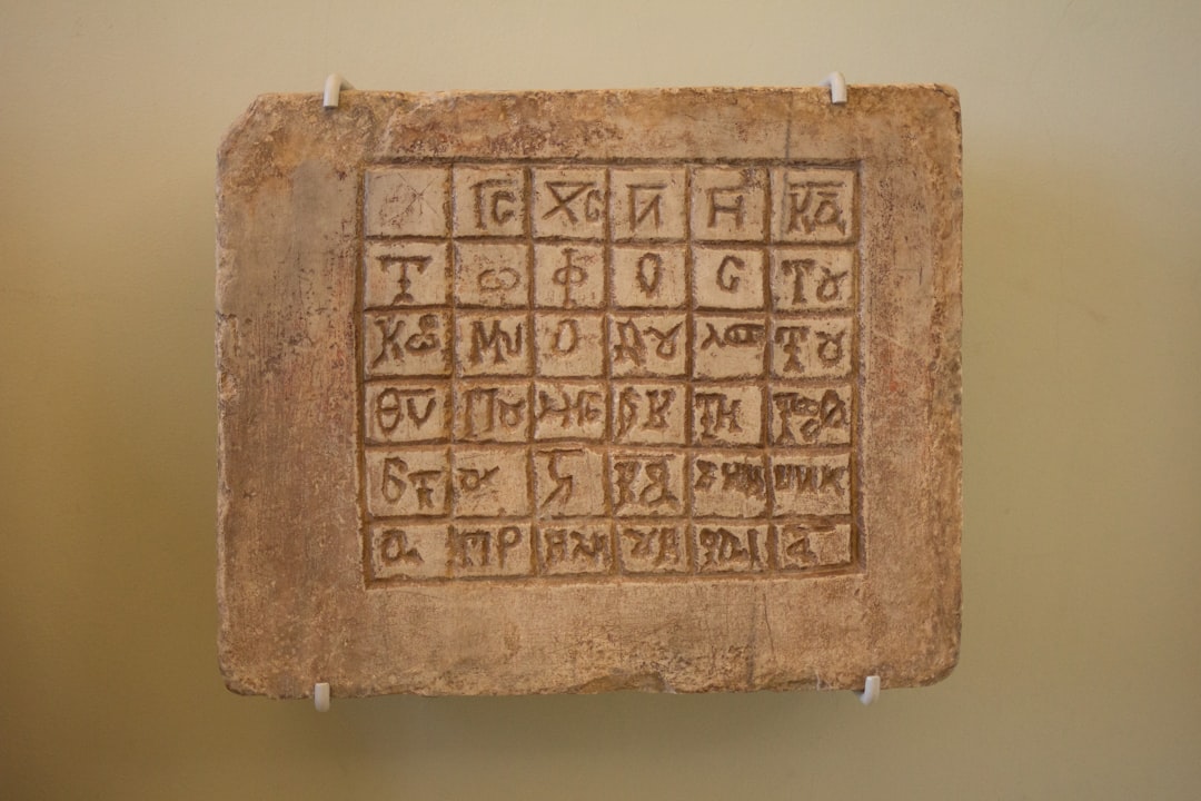 An ancient greek tombstone on display in a museum.