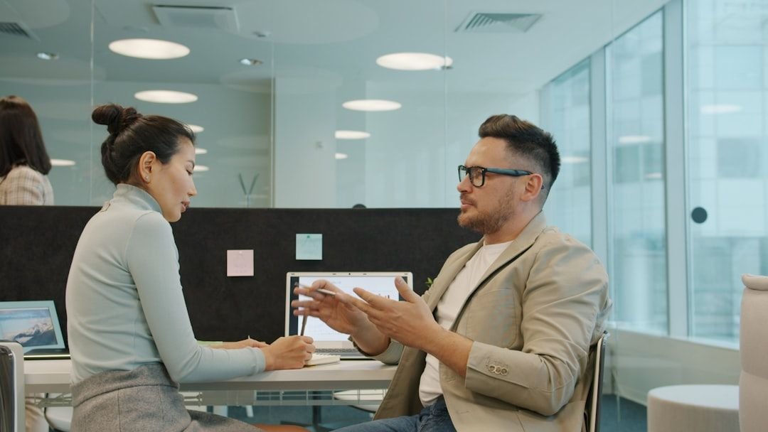 Two Taiwan professionals discussing English if clauses at the office