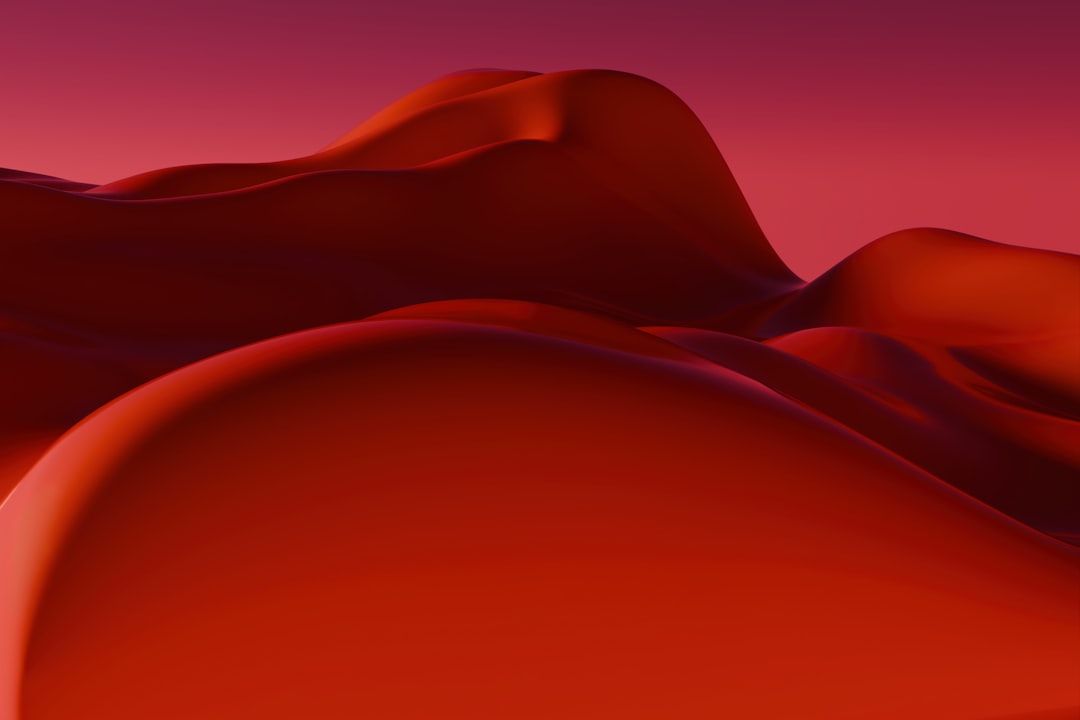 Abstract red desert dunes under a gradient sky