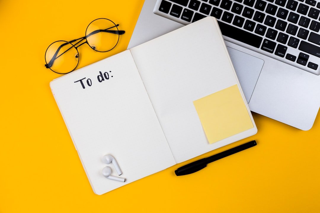 Home office desk workspace with laptop on yellow background. Flat lay, top view girl boss work business concept. Work at home