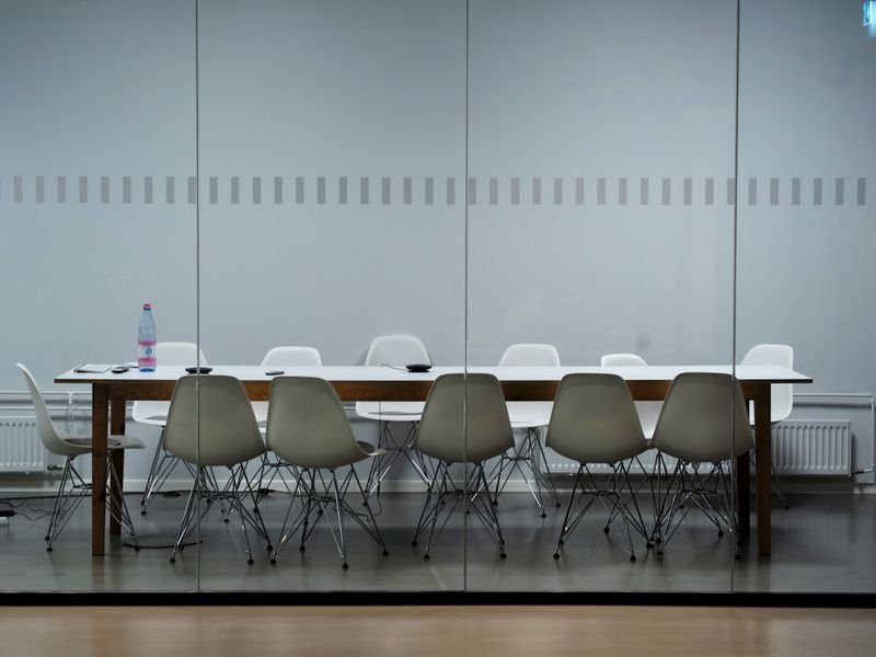 Empty conference room — declining meetings 推掉會議 in polite refusal English