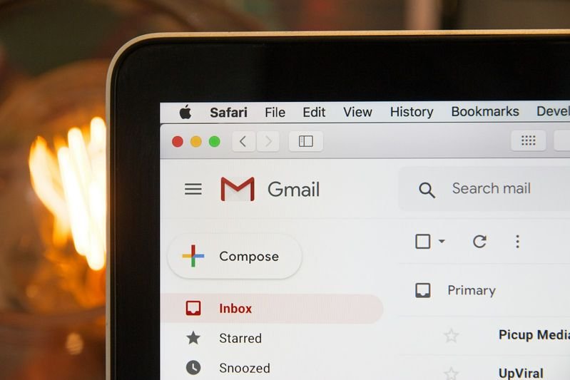 English email signature format for Taiwan professionals on a black laptop