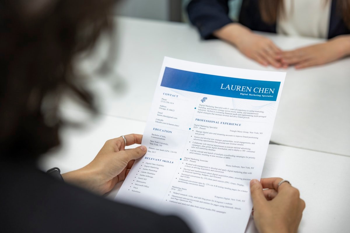 Hiring manager reviewing a resume during an English job interview 英文履歷面試