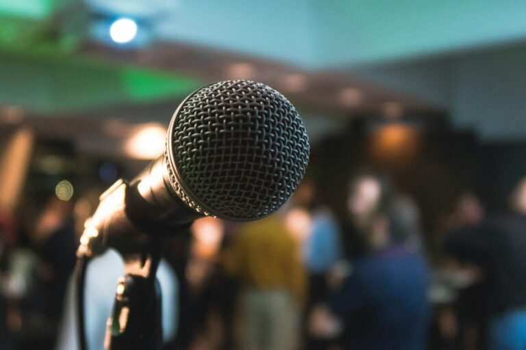 Person speaking into a microphone — practicing English pronunciation 英文發音