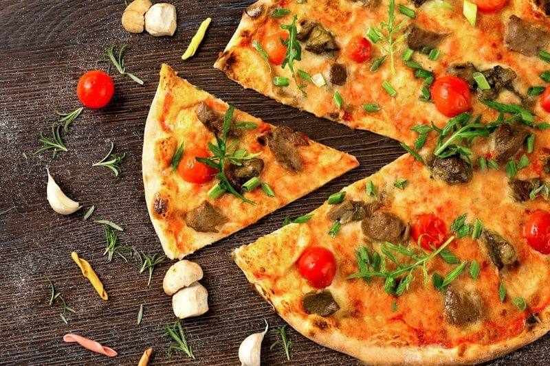 A pizza cut into slices to explain fractions like one quarter and three quarters in English