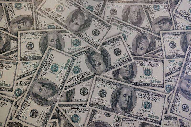 Stacks of US one hundred dollar bills representing large numbers like million and billion