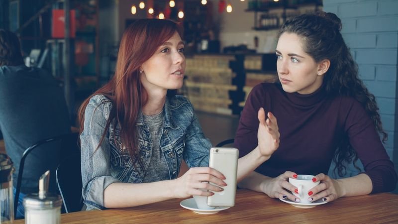 Two women practicing English phrasal verbs in everyday daily conversation