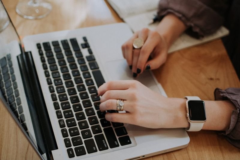 Hands typing on laptop — Email 婉拒回信 polite refusal English email phrases