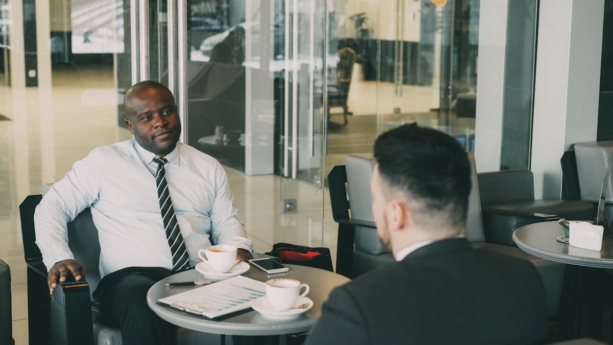 Two businessmen in a cafe refusing a deal in English — 拒絕英文 商務情境