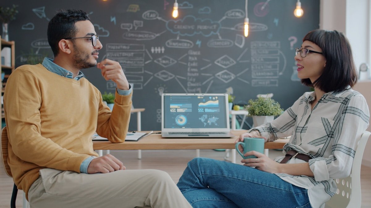 Coworkers discussing why a colleague said no in English at work