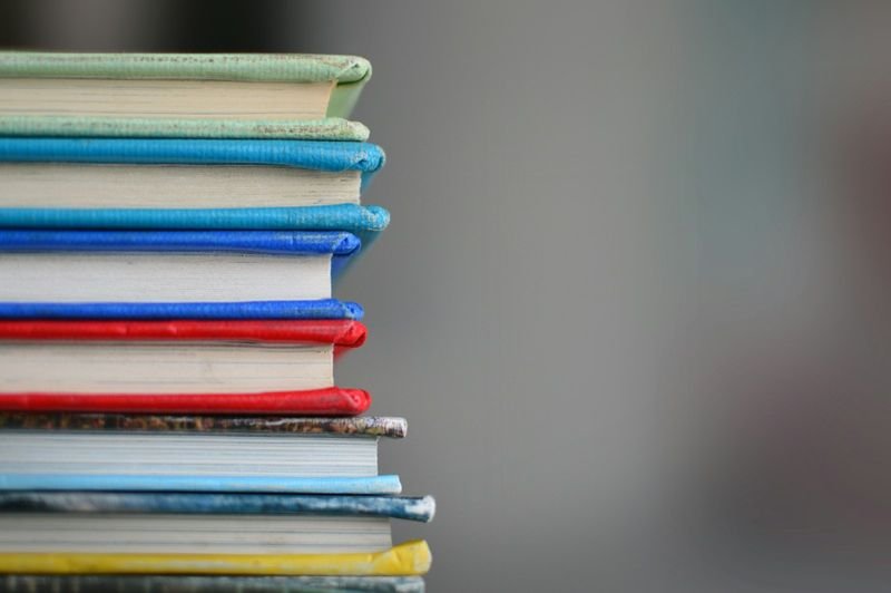 Stack of English grammar books covering reported speech and indirect questions