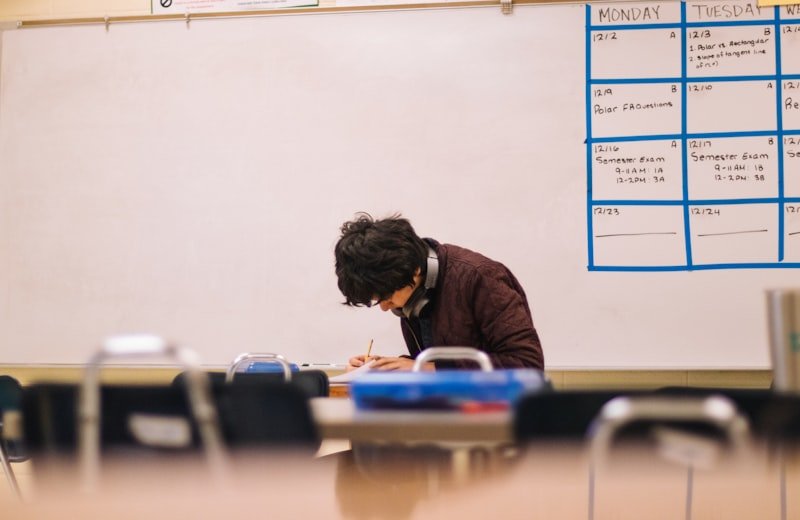 Taiwan student studying English prepositions in on at with a workbook