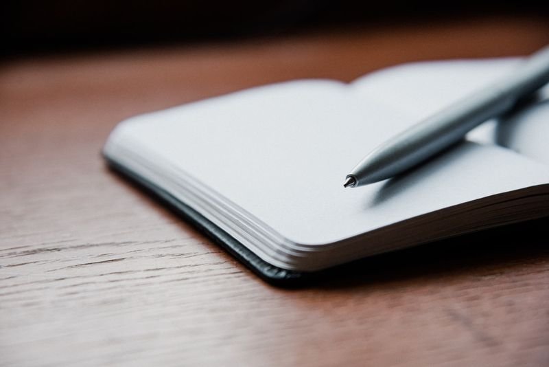 Notebook and pen for taking a phone message in English