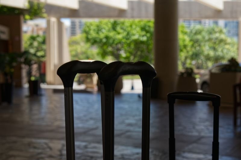 Luggage handles in a hotel lobby — travel English for arrivals 出國英文
