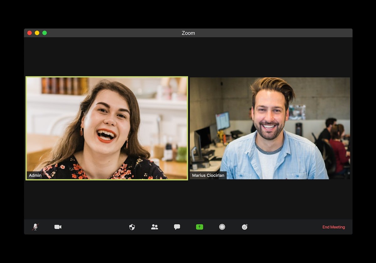 video call apology English Zoom meeting two professionals smiling