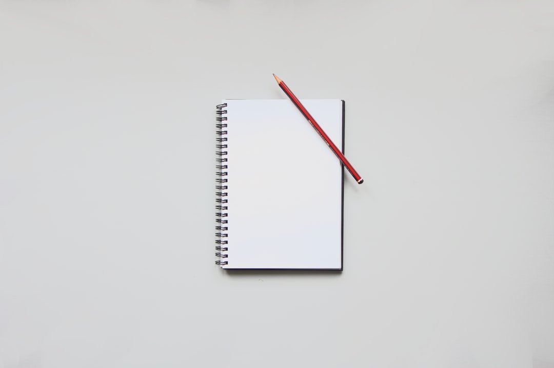 a notebook with a pencil on top of it