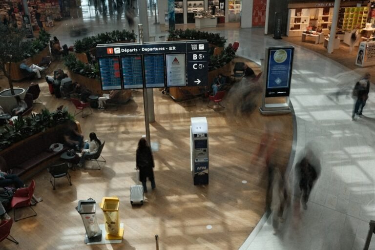 Busy airport terminal with people and departure boards