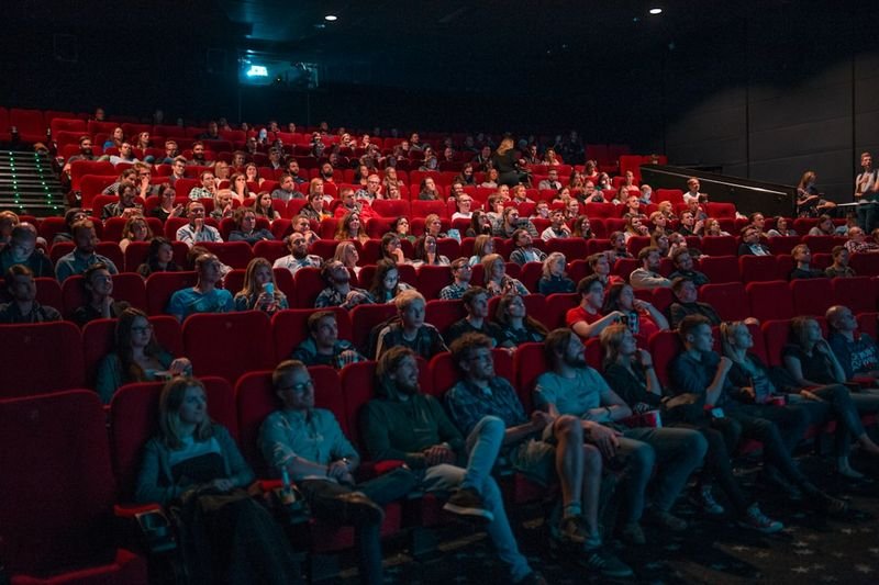 Audience watching a film with English subtitles
