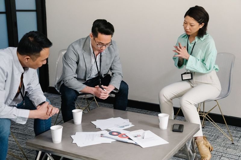 business meeting Taiwan professionals discussing contrasting views concession language