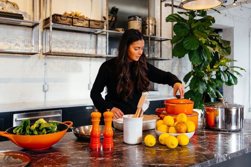 A woman is cooking right now — present continuous example