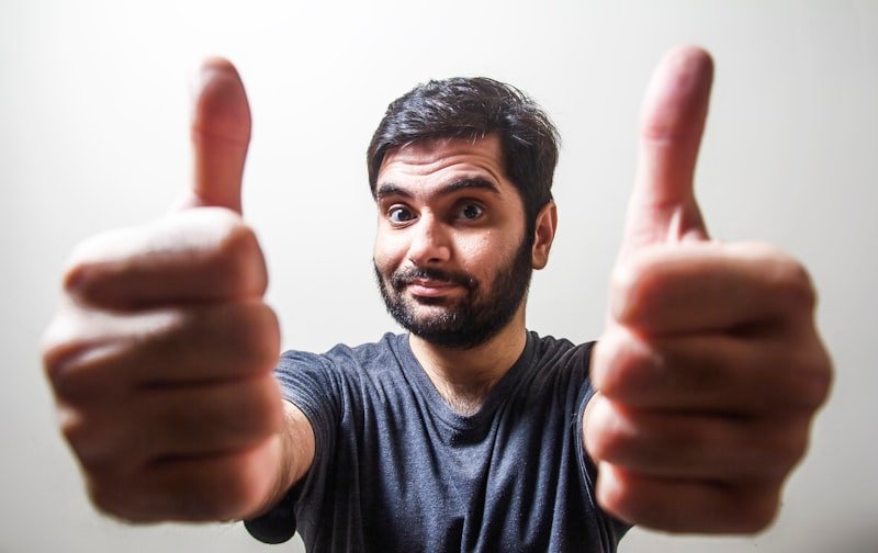 Happy customer giving thumbs up after complaint resolved successfully in English