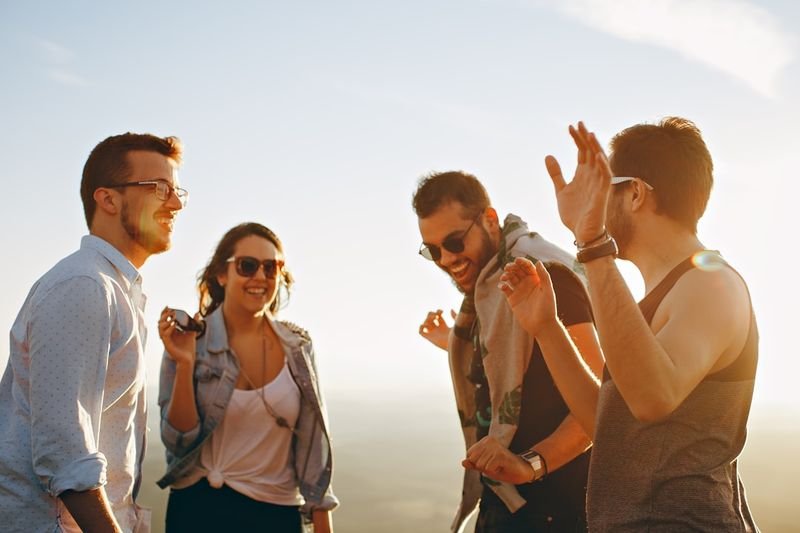 Friends using English conversation greetings and small talk outdoors