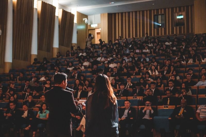 Taiwanese audience listening to an English presentation in an auditorium
