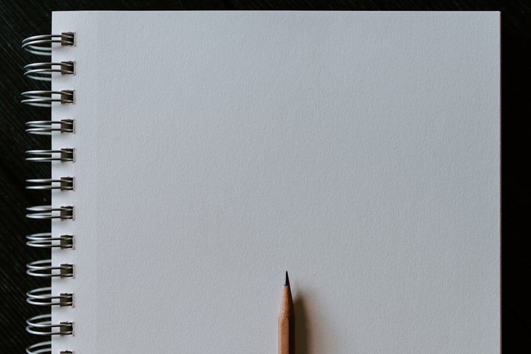 Wooden pencil on blank spiral notebook