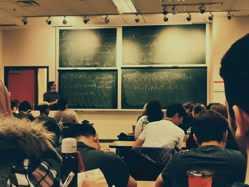 ESL teacher explaining classroom game rules to a class