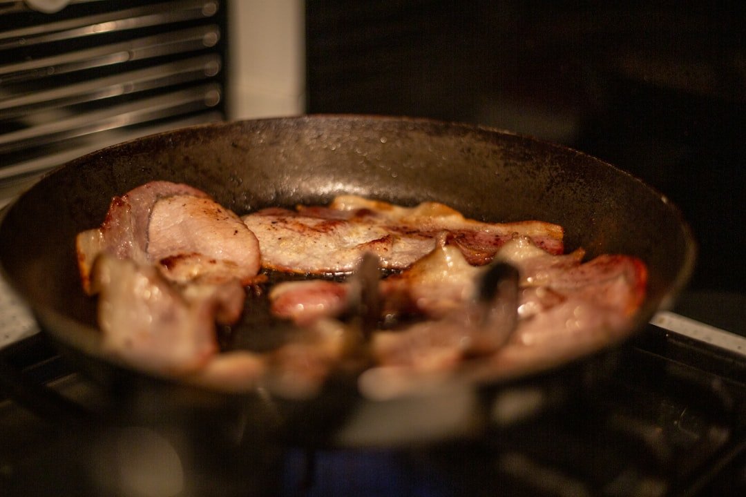 Bacon frying in a pan &mdash; bringing home the bacon