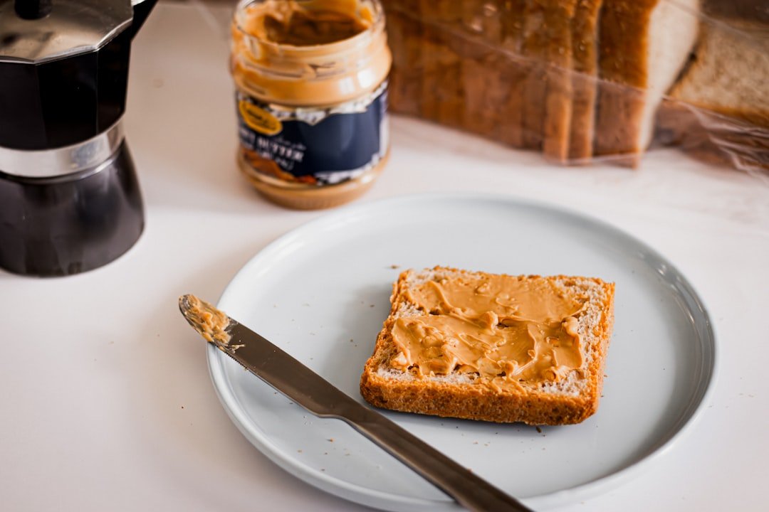 Spreading butter on bread &mdash; buttering someone up