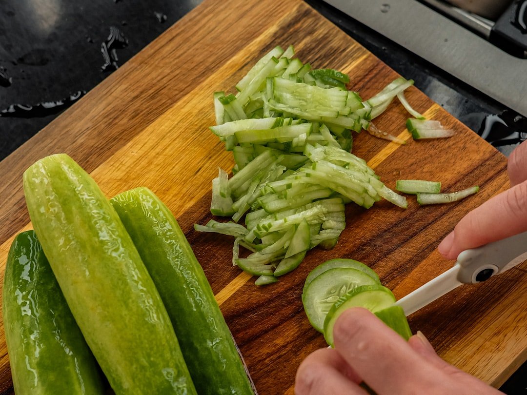 Fresh cucumber being sliced &mdash; cool as a cucumber