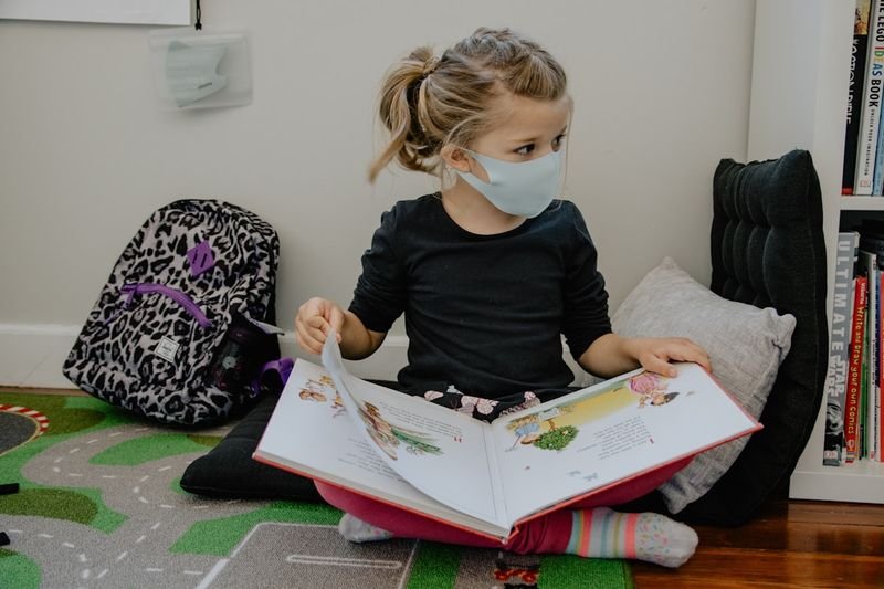 兒童英文 young child reading an English picture book in class