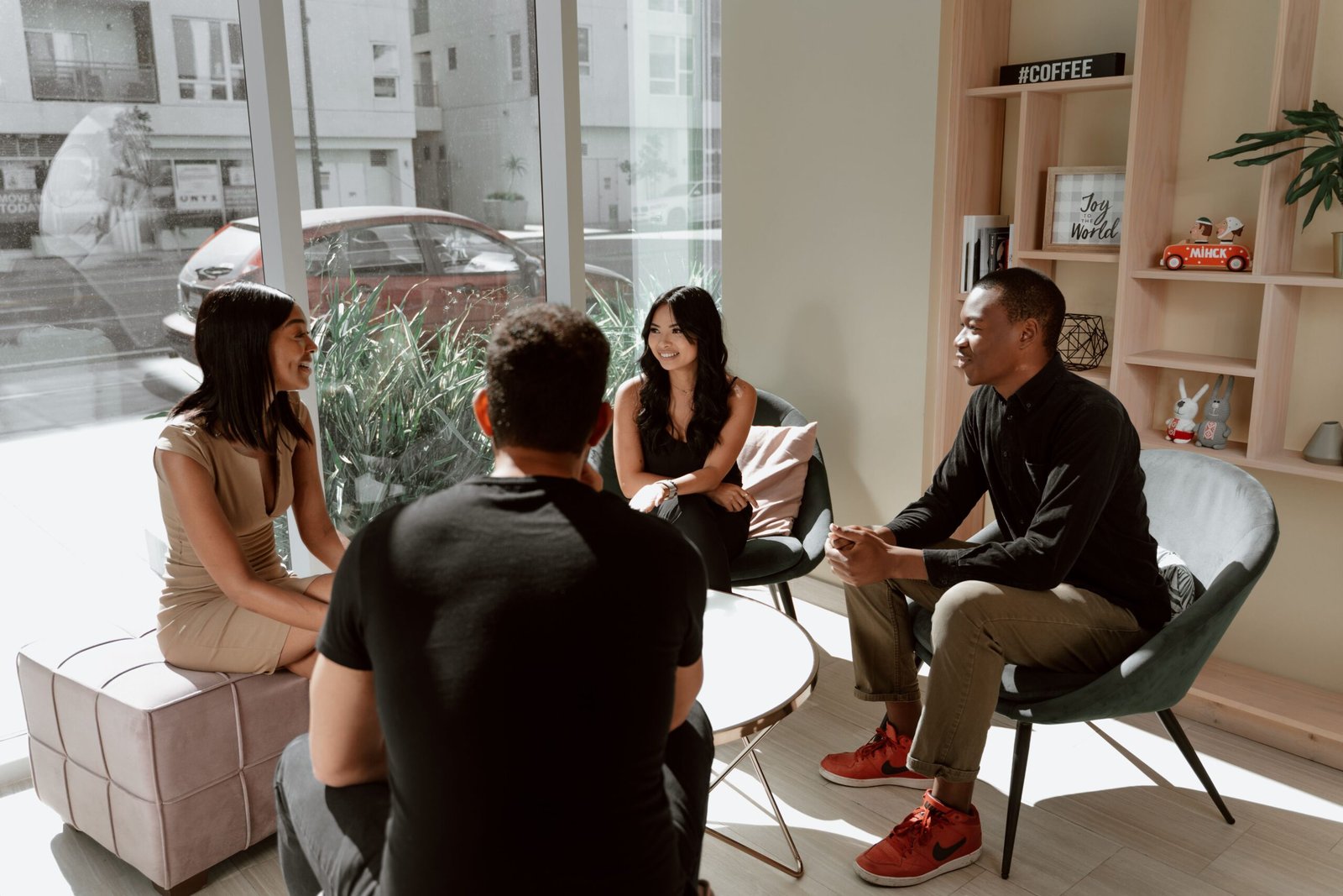 A group of 4 people sitting and having a conversation