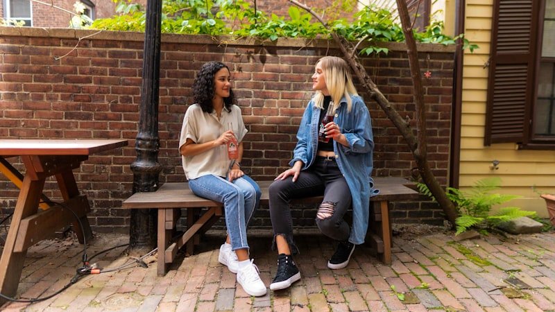 Two friends chatting casually and using common slang words