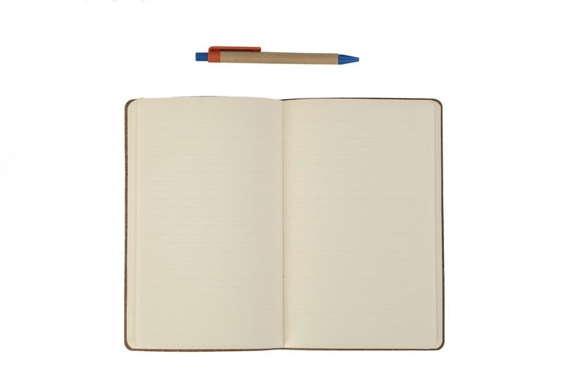 Notebook and pen for practicing past simple vs past continuous grammar